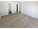 Spacious bedroom with neutral carpet and gray walls, featuring doors to other rooms at 8253 Penwood Dr, Port Richey, FL 34668