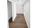 Hallway with wood flooring and white trim, leading to the front door at 8253 Penwood Dr, Port Richey, FL 34668