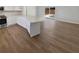 Open concept kitchen and living area with long island and modern flooring at 8253 Penwood Dr, Port Richey, FL 34668