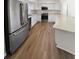 Bright kitchen with stainless steel appliances, white cabinets, and granite countertops at 8253 Penwood Dr, Port Richey, FL 34668