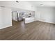 Open-concept living room and kitchen area with stainless steel appliances at 8253 Penwood Dr, Port Richey, FL 34668
