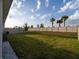 Spacious backyard featuring a well-maintained lawn, vinyl fence, and a blue sky at 17737 Canopy Pl, Bradenton, FL 34211