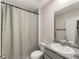 Clean bathroom features a single sink with granite countertop, tile floor, and shower with curtain at 17737 Canopy Pl, Bradenton, FL 34211