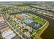 Overhead view of the community pool, clubhouse, tennis courts, and nearby lake at 17737 Canopy Pl, Bradenton, FL 34211