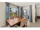 Bright dining area featuring a wood table, comfortable seating, and a sliding glass door with backyard views at 17737 Canopy Pl, Bradenton, FL 34211