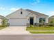 Charming single-story home featuring a two-car garage, inviting front entrance, and beautifully landscaped front yard at 17737 Canopy Pl, Bradenton, FL 34211