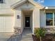 Close up of the front door, garage and decorative stone facade at 17737 Canopy Pl, Bradenton, FL 34211