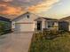 Charming single-Gathering home featuring a two-car garage and a beautifully landscaped front yard at 17737 Canopy Pl, Bradenton, FL 34211