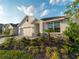 Well-maintained front yard featuring lush landscaping, mulch beds, and a view of the home's facade at 17737 Canopy Pl, Bradenton, FL 34211