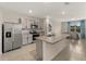 Well-equipped kitchen with stainless steel appliances, granite countertops, and an open layout to the dining area at 17737 Canopy Pl, Bradenton, FL 34211