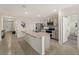 Modern kitchen featuring a central island with a sink, stainless steel appliances, and ample counter space at 17737 Canopy Pl, Bradenton, FL 34211
