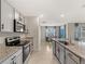 Stylish kitchen featuring granite countertops, modern appliances, and an open view to the dining area, creating a functional space at 17737 Canopy Pl, Bradenton, FL 34211