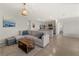 Open-concept living room featuring a spacious seating area, tile floors, and seamless flow to the kitchen at 17737 Canopy Pl, Bradenton, FL 34211