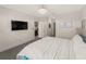 Spacious bedroom boasts a decorative wall, ceiling light fixture, and doorway to the kitchen at 17737 Canopy Pl, Bradenton, FL 34211