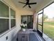 View of screened patio with ceiling fan, table, and an umbrella at 17737 Canopy Pl, Bradenton, FL 34211