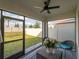 Relaxing screened patio with seating, a ceiling fan, and view of the backyard at 17737 Canopy Pl, Bradenton, FL 34211