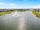 Scenic aerial view of the pond with a fountain and the neighboring houses at 17737 Canopy Pl, Bradenton, FL 34211