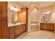 Spacious bathroom featuring dual vanities, a soaking tub, and wood cabinetry at 2202 Sparkman Rd, Plant City, FL 33566
