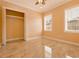 Bright bedroom with tile flooring, a ceiling fan, two windows, and a closet space at 2202 Sparkman Rd, Plant City, FL 33566
