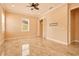 Bright bedroom featuring neutral walls, tile flooring, a ceiling fan, and a closet space at 2202 Sparkman Rd, Plant City, FL 33566