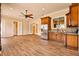 Open kitchen with stainless appliances, wood cabinets and tile floors at 2202 Sparkman Rd, Plant City, FL 33566