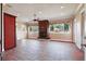 Open living room area with hardwood floors, fireplace, and exterior views at 2202 Sparkman Rd, Plant City, FL 33566