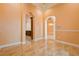 Spacious open-concept living area featuring arched doorways, marble floors, and a decorative chandelier at 2202 Sparkman Rd, Plant City, FL 33566