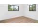 Bright bedroom featuring ample natural light from two windows and clean, minimalist finishes at 2239 Worrington St, Sarasota, FL 34231