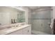 Modern bathroom featuring tiled walk-in shower, decorative tile accent, and granite countertop at 25416 Jubal St, Punta Gorda, FL 33955