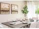 Formal dining area with stylish table setting, modern artwork, and elegant decor at 25416 Jubal St, Punta Gorda, FL 33955