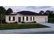 Charming single-Gathering home with a well-maintained lawn, neutral tones, and classic architectural design at 25416 Jubal St, Punta Gorda, FL 33955