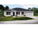 Traditional home featuring professional landscaping, a two-car garage, and neutral colors at 25416 Jubal St, Punta Gorda, FL 33955