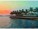 Scenic waterfront view at sunset featuring palm trees, a bridge, and a calm body of water at 25416 Jubal St, Punta Gorda, FL 33955