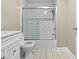 Updated bathroom features white subway tile in shower, modern fixtures, and tile flooring at 5004 E Seneca Ave, Tampa, FL 33617