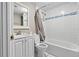 Clean bathroom with a shower-tub combo, white tile, and modern fixtures at 5004 E Seneca Ave, Tampa, FL 33617