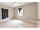 Neutral bedroom with light wood floors, ceiling fan, and window with dark coverings at 5004 E Seneca Ave, Tampa, FL 33617