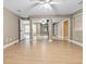 Spacious bedroom with wood-look flooring, ceiling fan, and mirrored closet doors for ample storage at 5004 E Seneca Ave, Tampa, FL 33617