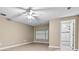 Bright bedroom featuring ceiling fan and ensuite bathroom with tiled shower and modern fixtures at 5004 E Seneca Ave, Tampa, FL 33617