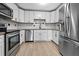 Bright kitchen featuring stainless steel appliances and modern white cabinetry at 5004 E Seneca Ave, Tampa, FL 33617