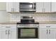Close-up of kitchen appliances, highlighting the stainless steel oven and microwave at 5004 E Seneca Ave, Tampa, FL 33617