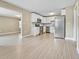 Spacious open-concept kitchen with stainless steel appliances and white cabinets at 5004 E Seneca Ave, Tampa, FL 33617