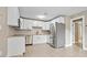 Modern kitchen with stainless steel appliances and white cabinets, offering a spacious layout at 5004 E Seneca Ave, Tampa, FL 33617