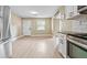 Open living area showcasing modern finishes, leading to the kitchen at 5004 E Seneca Ave, Tampa, FL 33617