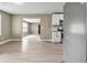 Open-concept living room with wood flooring and adjoining kitchen at 5004 E Seneca Ave, Tampa, FL 33617