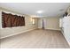 Spacious living room with wood-look floors, large windows, and access to other areas of the house at 5004 E Seneca Ave, Tampa, FL 33617