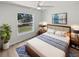 Comfortable bedroom with a large window and a ceiling fan, offering a serene view of the backyard at 5028 Oakshire Dr, Tampa, FL 33625
