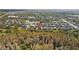 Aerial view of the property in a vibrant neighborhood, backing onto a wooded area and serene pond at 11818 Gilmerton Dr, Riverview, FL 33579