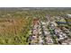 Expansive aerial view of a suburban neighborhood with lush greenery and a tranquil pond at 11818 Gilmerton Dr, Riverview, FL 33579