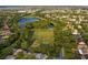 An aerial view showing a lake, green fields, and homes in a well-planned neighborhood at 11818 Gilmerton Dr, Riverview, FL 33579