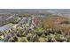 Aerial view of a well-situated home in a leafy neighborhood near a pond and bordering a forest at 11818 Gilmerton Dr, Riverview, FL 33579